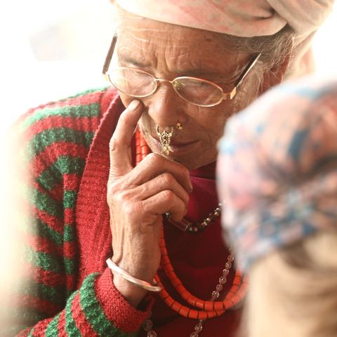 A woman tests her new donated glasses, ensuring her vision remains clear