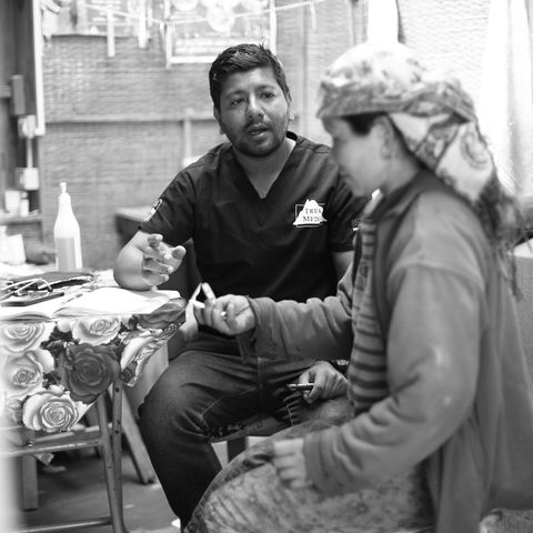 Nepalese doc Sulav teaching a patient how to take her medication